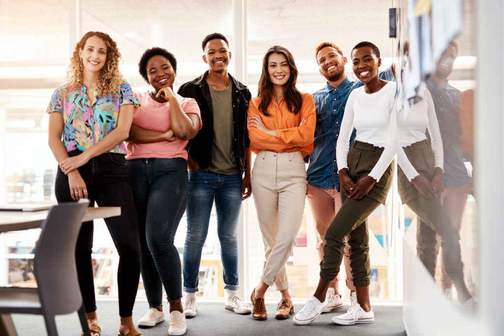 Diverse group of young professionals standing together, representing growth and opportunity in marketing careers.